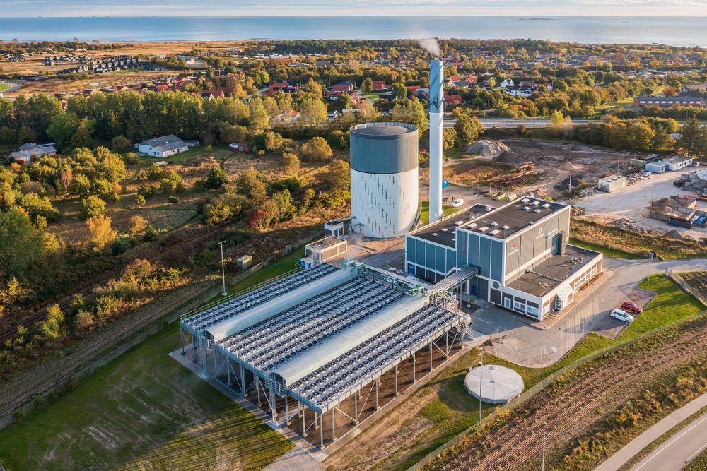 Aerial view of an energy centre with rows of air source heat pump units beside the main building.